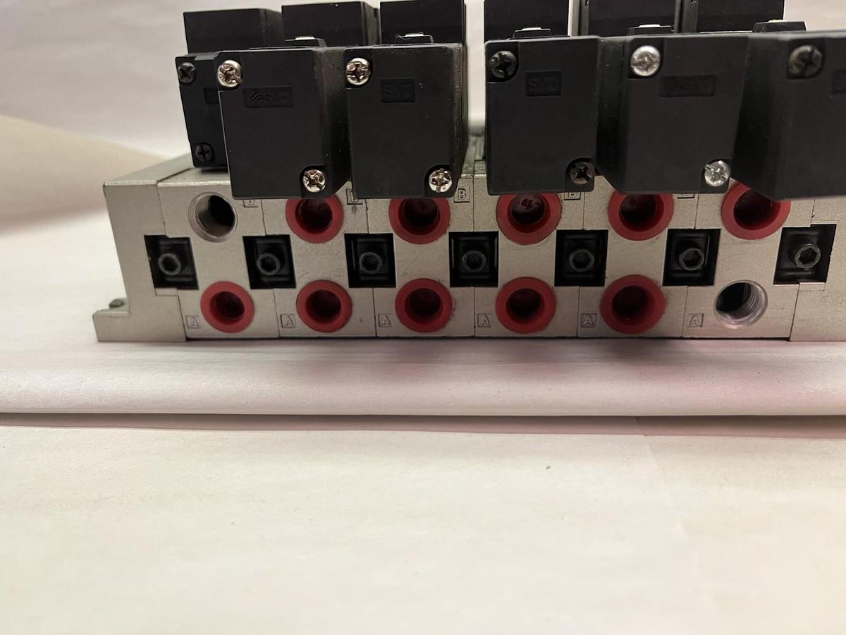 Used SMC,NVFS2200-5FZ,PNEUMATIC VALVE BANK 1/4" NPT W/ 6 SOLENOID VALVES DC 21-26V