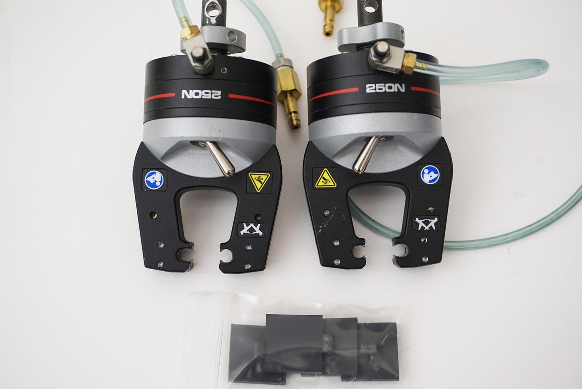 Used Instron 2712-052 Pair Pneumatic Grips 250N Capacity with new 1"x1" smooth grip faces