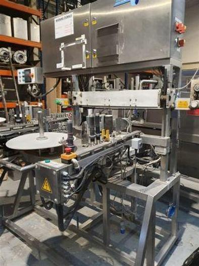 Used 2002 Graham Captain Twin Head Labeller with Top Hold Conveyor