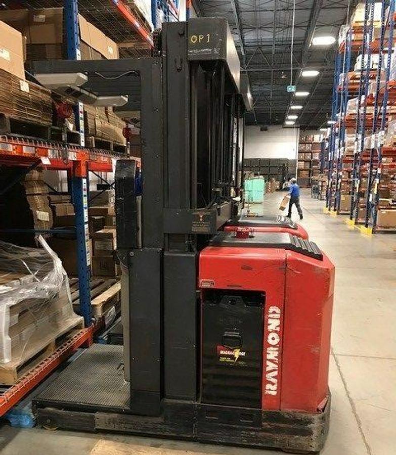 Side view of refurbished 1998 Raymond EASI-OPC30TT electric order picker showing battery compartment, chassis frame, and platform base during Vaughan deployment