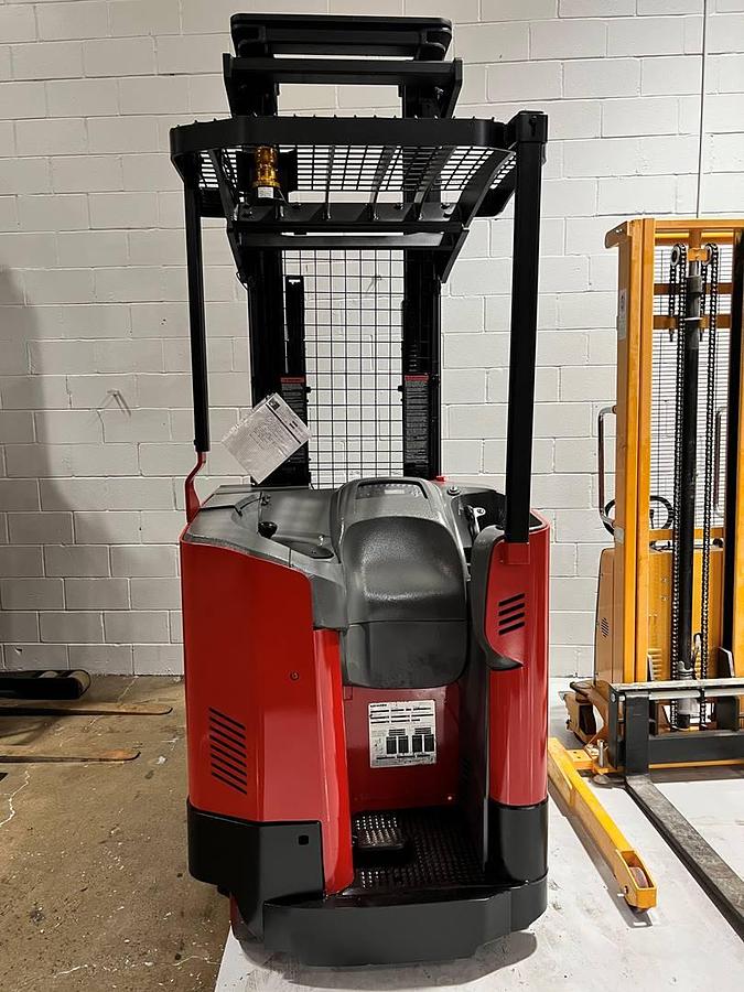Back view of Raymond 740-R45TT electric single-reach forklift with battery installed – CSA-certified 4,500 lb chassis showing operator compartment, forward-facing controls, overhead guard, and cushioned forward-stance platform staged in Brampton ON – Premier Lift Equipment
