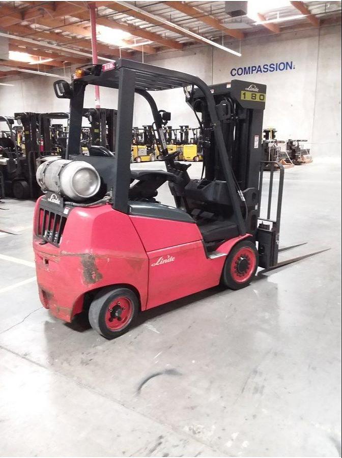 Rear side view of refurbished 2016 Linde H25CT LPG forklift showing rear chassis, solid tires, LP gas tank, and CSA certification decal during Brampton deployment.
