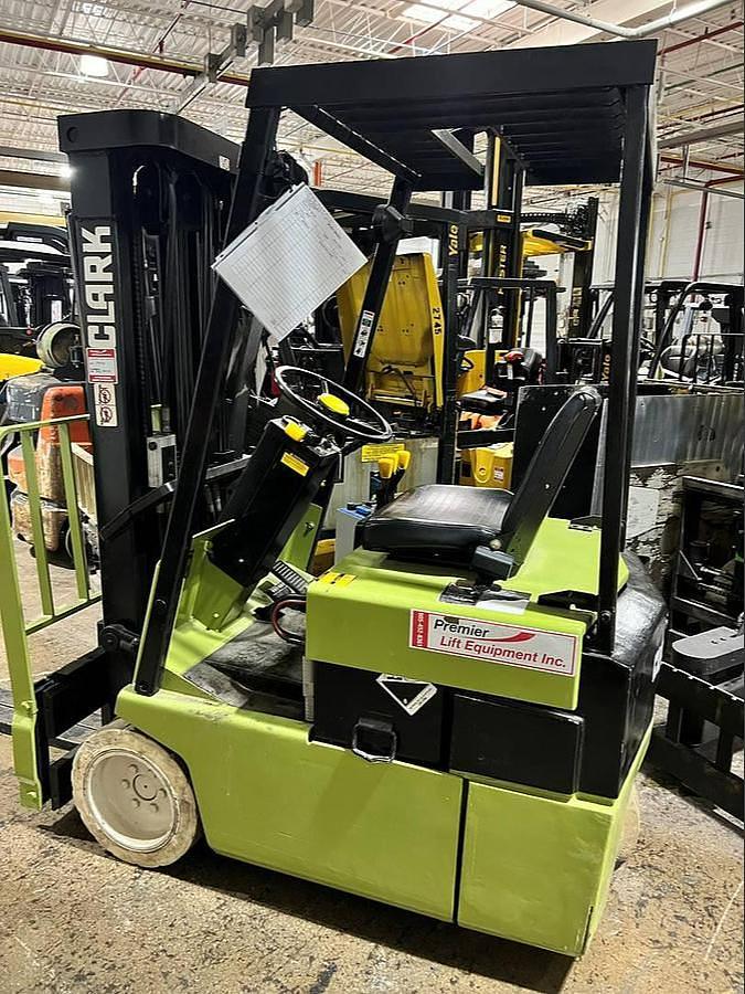 Older Clark TM15S three‑wheel electric forklift shown as an example of budget-tier electric equipment.