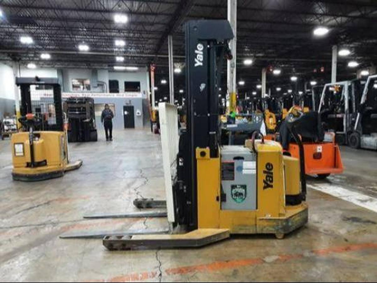 Opposite side view of refurbished 2011 Yale MR03030 electric walkie reach stacker showing 24V battery box, hydraulic lines, and CSA decal during Ontario deployment