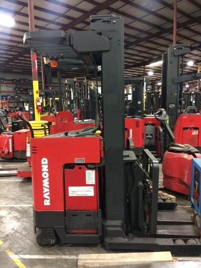 Side profile of Raymond EASIDR30TT electric deep-reach forklift showing extended mast rails, reach mechanism, and chassis layout during Brampton deployment