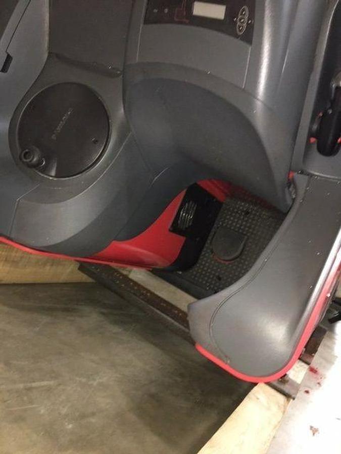 Close-up of Raymond 750DR32TT operator compartment showing steering wheel, instrument cluster, seat, and CSA safety decals during Brampton deployment