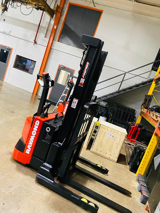 Unique Side view of CSA-certified Raymond RSS40 walkie stacker with 128” mast and poly tires – staged in Brampton ON