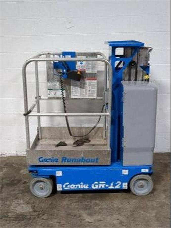 Genie GR-12 – side view – narrow chassis, platform rails, mast profile – electric vertical lift for indoor access – Brampton ON