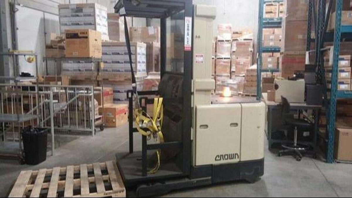Side view of refurbished 2001 Crown SP3000 electric order picker showing 195" mast, operator platform, and CSA certification decal during Ontario deployment.