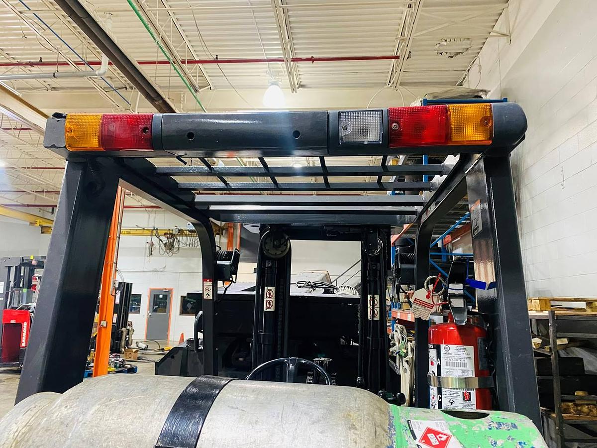 Overhead guard of refurbished Toyota LP gas forklift showing integrated light package and CSA compliance during Brampton deployment