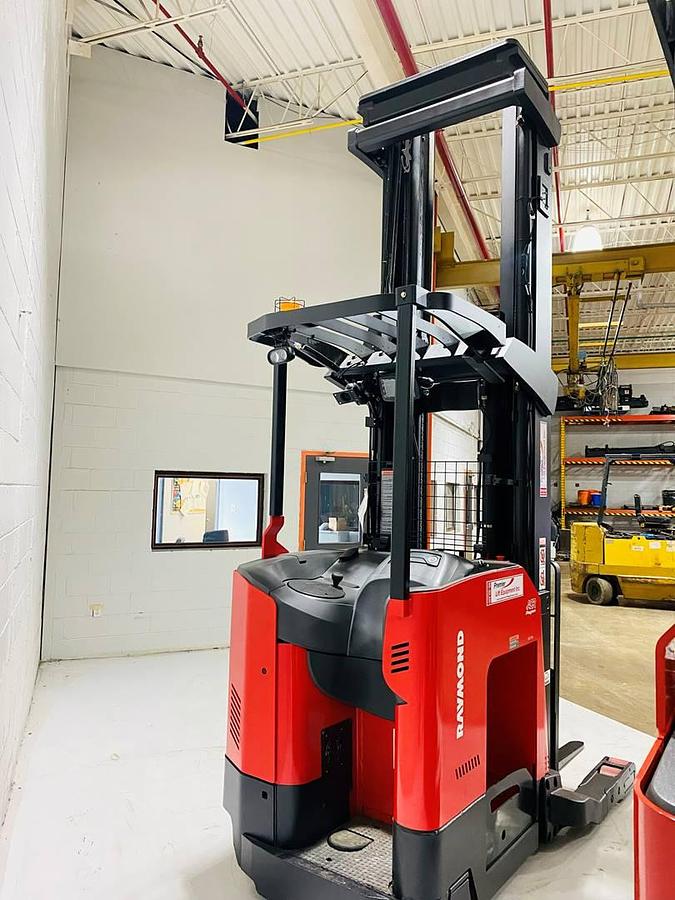Rear angle view of 2022 Raymond 752-R45TT freezer reach truck showing chassis-only build with open battery compartment, rear caster wheel, and poly drive tire – CSA certified unit staged in Brampton ON