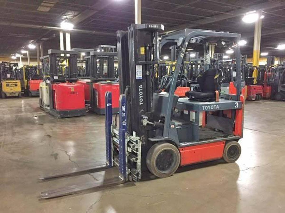 Side view of refurbished 2016 Toyota 8FBCHU25 electric 4-wheel sit-down forklift showing quad mast, CSA decal, and 4-way hydraulic lines during Ontario deployment
