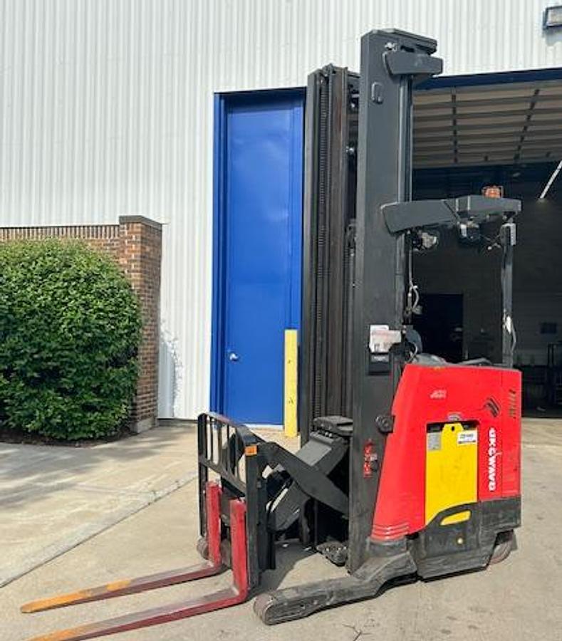 Front angle side view of 2020 Raymond 750-R45TT electric reach truck with carriage fully extended – CSA-certified 4,500 lb unit featuring 301” triple mast, 42” forks with side shift, poly cushion tires, and 36V AC chassis staged in Brampton ON; shown chassis only without battery or charger, available separately as extra options new or used – Premier Lift Equipment