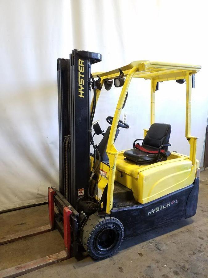 Side view of refurbished 2014 Hyster J40XNT 3‑wheel electric forklift showing 3‑stage mast, 42" forks, cushion tires, and CSA certification decal during Ontario deployment.