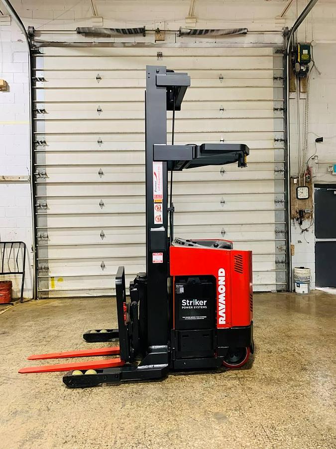 Side view of refurbished 2000 Raymond EASIR40TT electric reach truck showing battery compartment, chassis frame, and reach carriage in Mississauga inventory