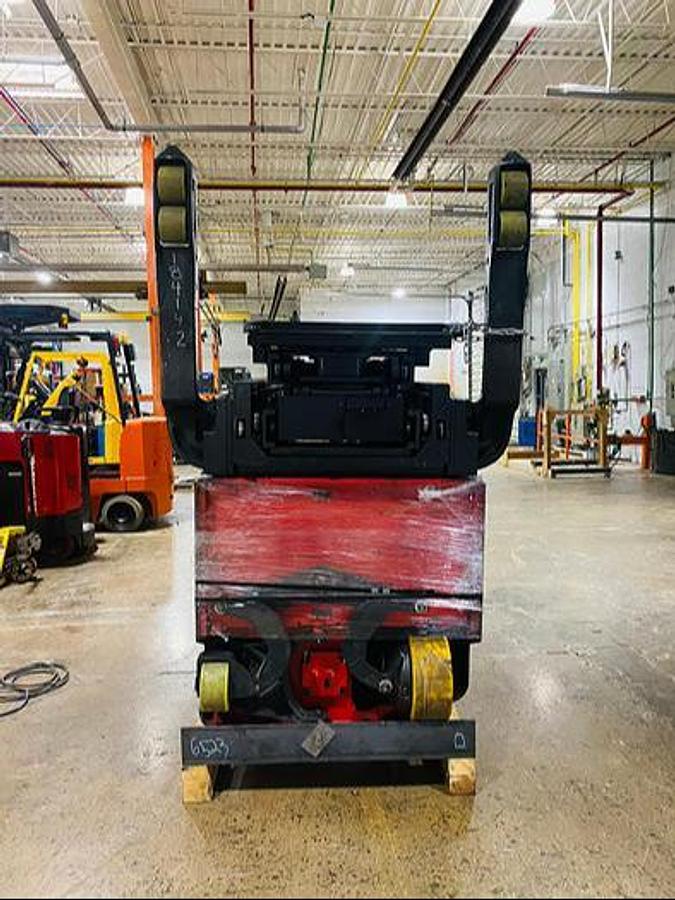 Underside view of cradled Raymond 750‑DR32TT chassis during transport prep