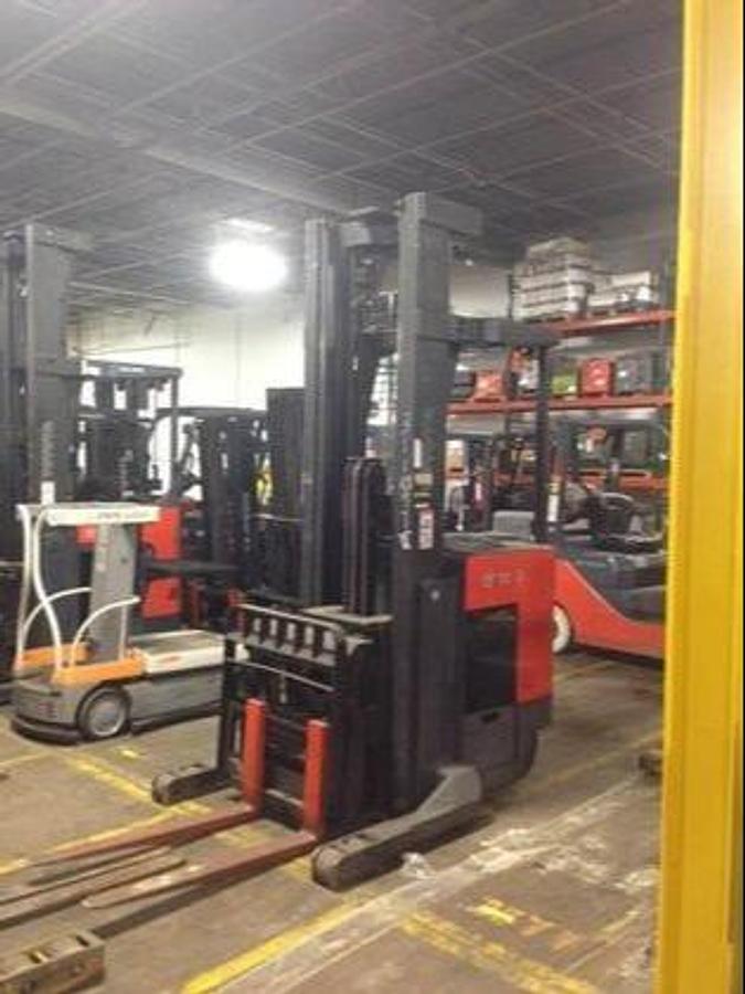 Front angle side view of refurbished 2007 Toyota 7BDRU15 electric double reach forklift showing fork tips, mast rails, and CSA certification decal during Ontario deployment