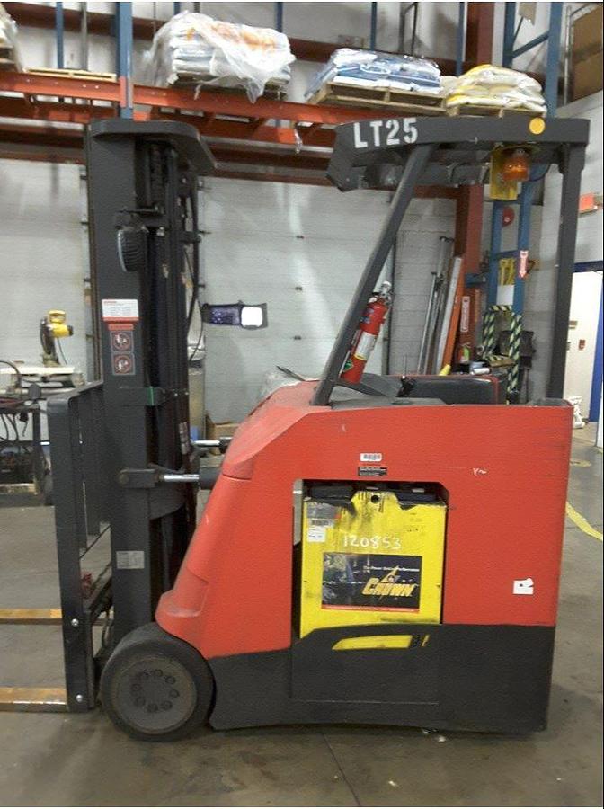 Side view of refurbished 2011 Raymond 425-C40TT electric dockstocker showing battery compartment, cushion tires, and chassis frame during Vaughan deployment