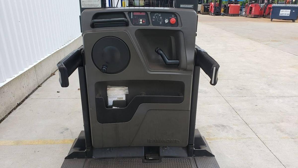 Interior view of refurbished 2013 Raymond 550-OPC30TT electric order picker showing operator controls, platform floor, safety rails, and CSA decals during Mississauga deployment
