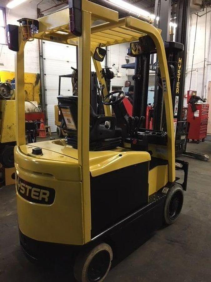 Rear side view of refurbished 2014 Hyster E55XN electric forklift showing rear chassis, non‑marking tires, and CSA certification decal during Ontario deployment.