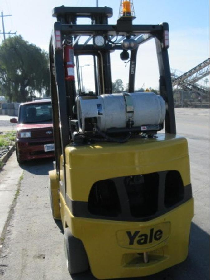 Rear view of refurbished 2013 Yale GLC070VX LPG cushion forklift showing counterweight, rear tires, and propane tank bracket during Brampton deployment