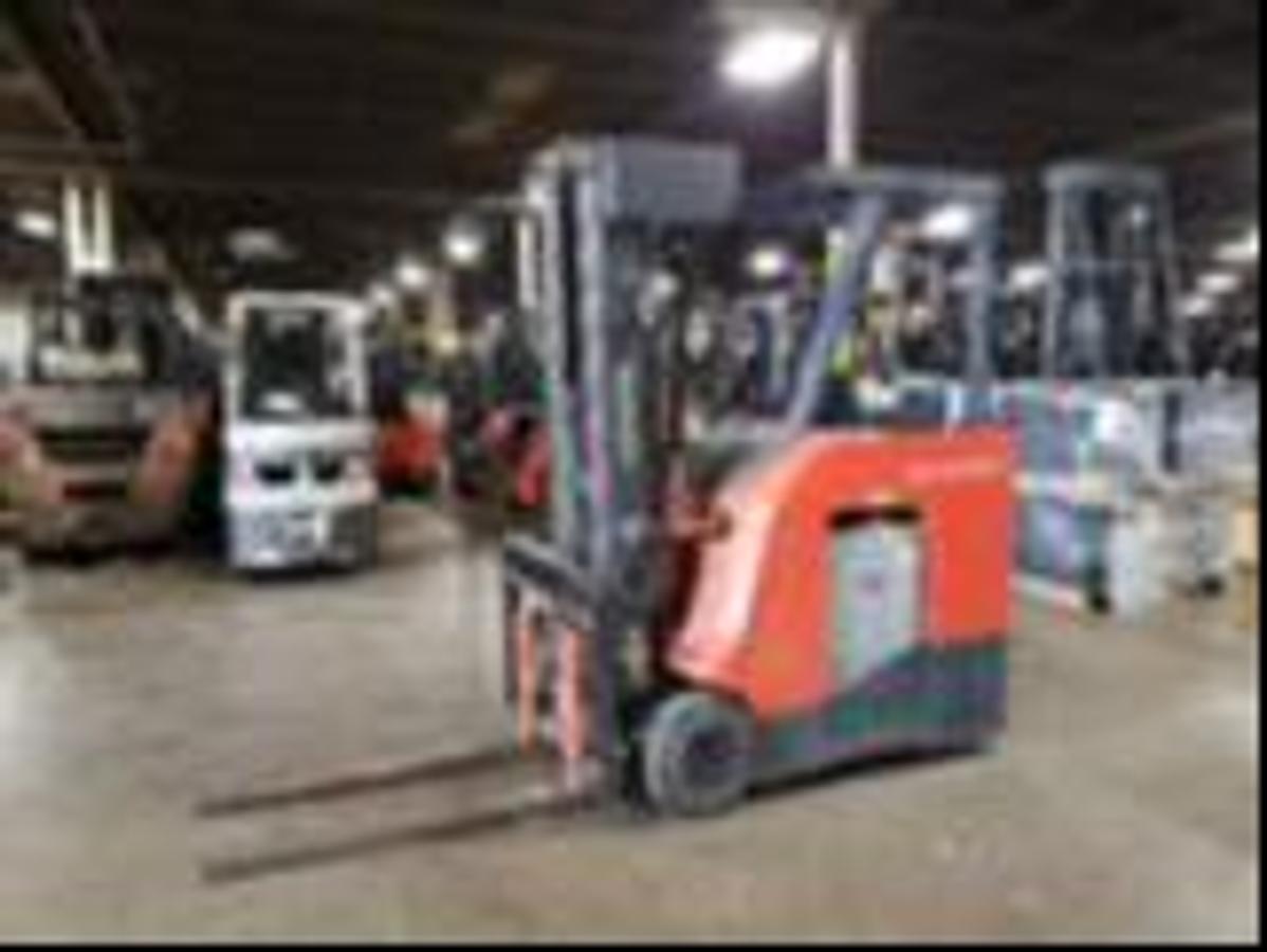 Side view of refurbished 2017 Toyota 8FBNCU20 electric counterbalance forklift showing SS/FP attachment, CSA decal, and 42" forks during Ontario deployment