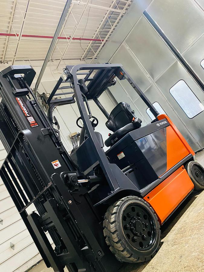 Used 2020 Toyota 8FBCU32-EE electric forklift with 187" triple mast and EE rating shown at front side angle during Brampton deployment