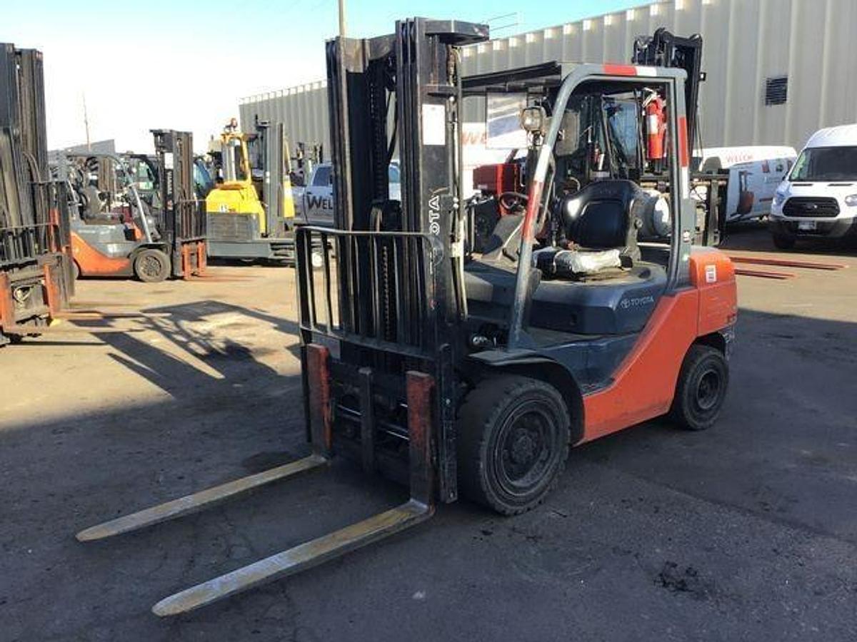 Front view of refurbished 2016 Toyota 8FGU30 LP gas forklift showing mast, carriage, and solid pneumatic tires during Brampton deployment