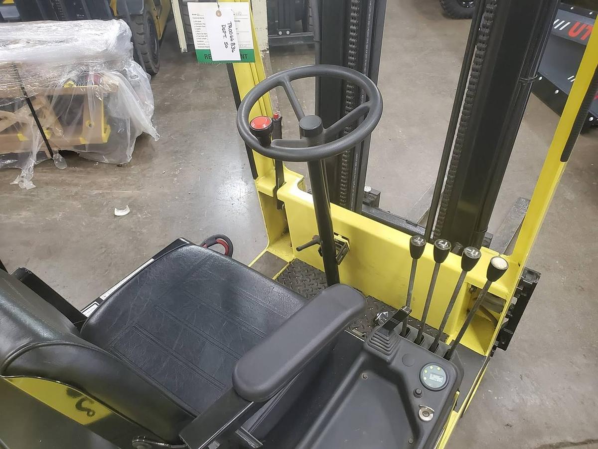 Operator compartment of refurbished 2008 Mariotti ME10 3‑wheel electric forklift showing steering wheel, electric controls, 2‑stage mast with side shift, and CSA certification decal during Brampton deployment.