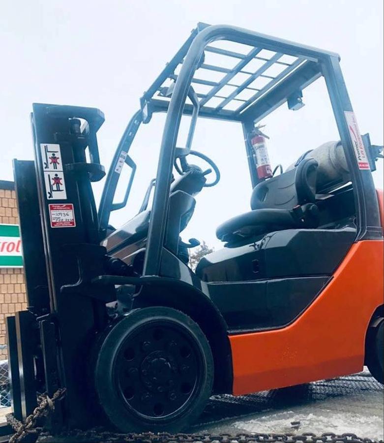 Opposite side view of refurbished 2013 Toyota 8FGCU25 LP gas forklift showing operator cab, rear chassis, and CSA decal during Brampton deployment