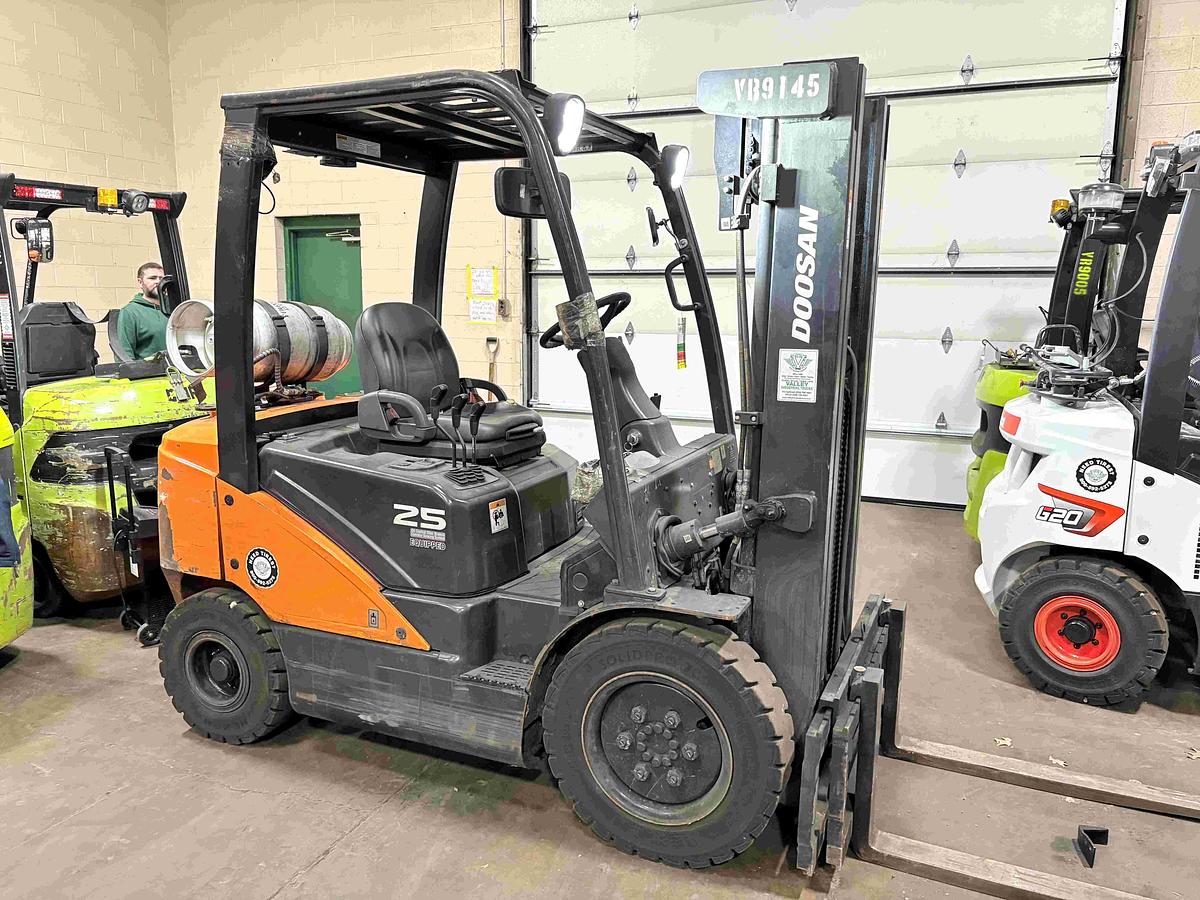 Opposite side view of 2021 Doosan G25N‑7 5,000 lb pneumatic tire LPG forklift showing counterweight, LPG tank area, and pneumatic tires