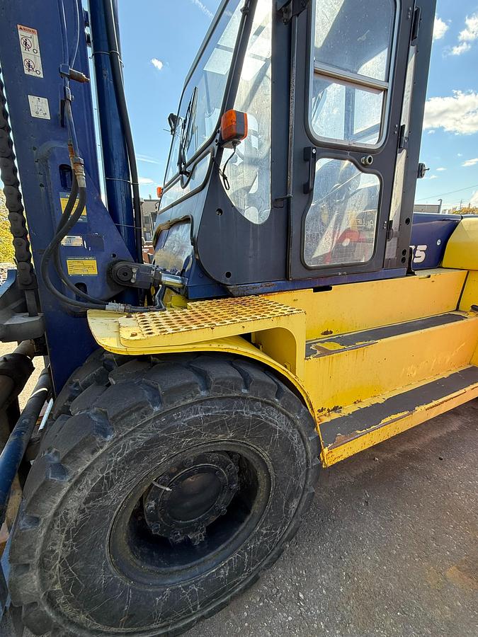 Komatsu FD135T‑6 forklift driver’s side front drive pneumatic tire and chassis