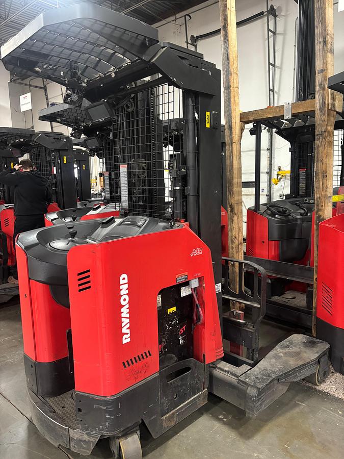 Rear‑side angle view of a Raymond 731‑4D‑R45TT four‑directional electric forklift showing counterweight, operator compartment, and slab chassis.