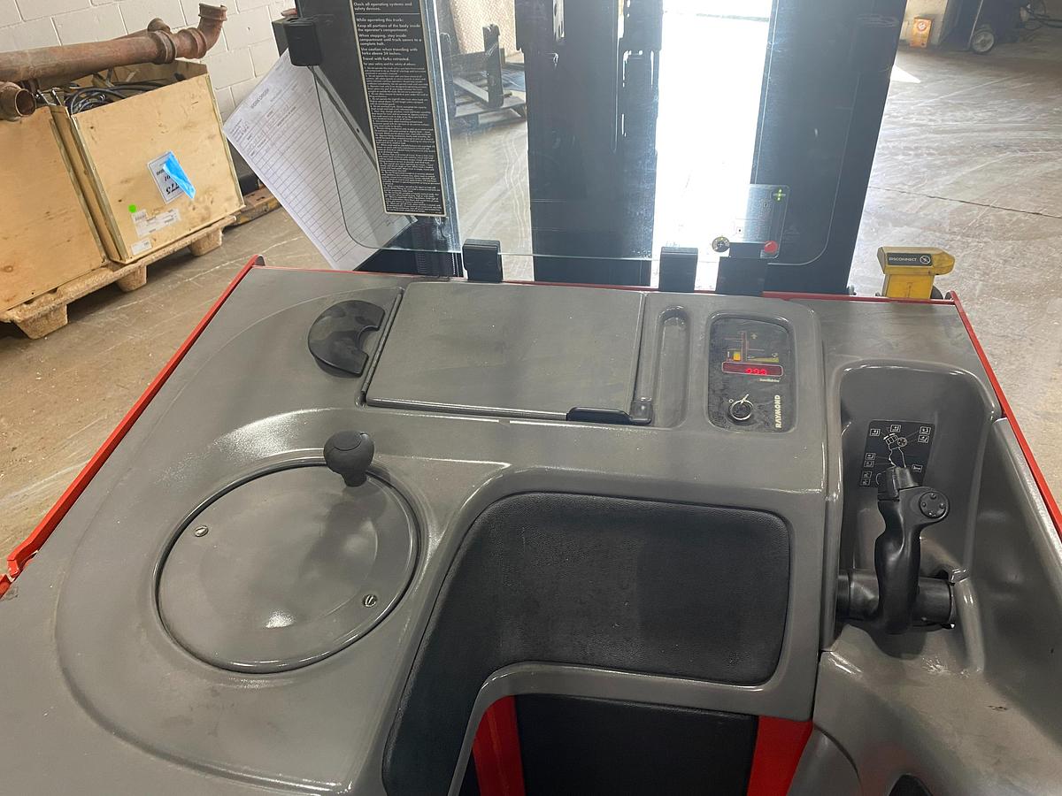 Operator controls of Raymond EASI forklift showing ergonomic steering wheel, levers, and CSA inspection tag