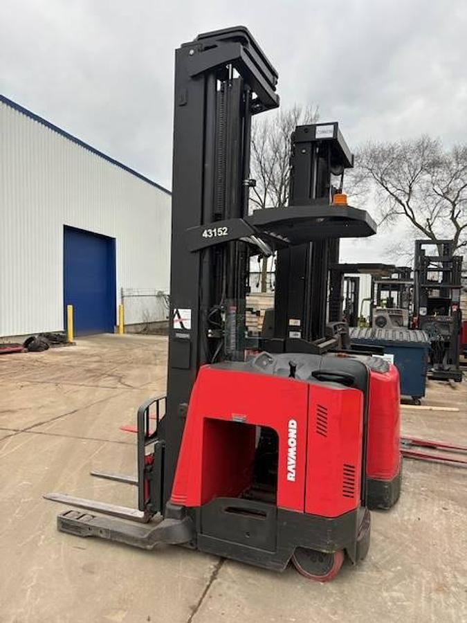 Side profile of Raymond 750DR32TT electric deep-reach forklift showing extended mast rails, reach mechanism, and chassis layout during Brampton deployment
