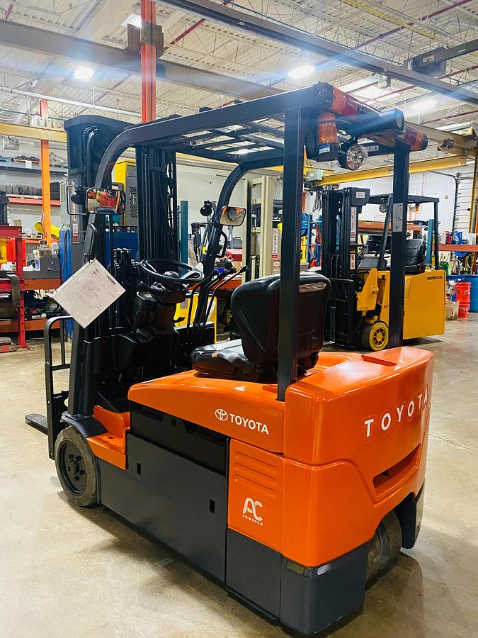 Toyota 7FBEU20 – reverse rear angle – steering column, rear tires, and safety decals – CSA/MOL certified electric forklift – Brampton ON