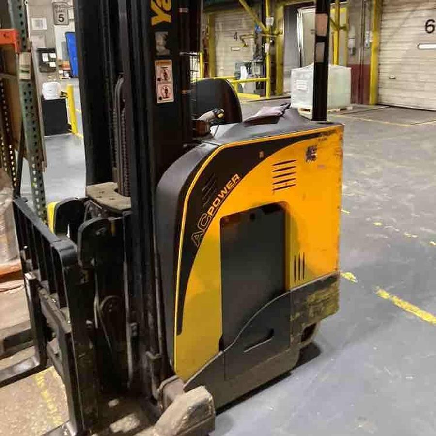 Side view of refurbished 2016 Yale NDR030DB electric double reach forklift showing mast rails, CSA decal, and freezer package during Ontario deployment