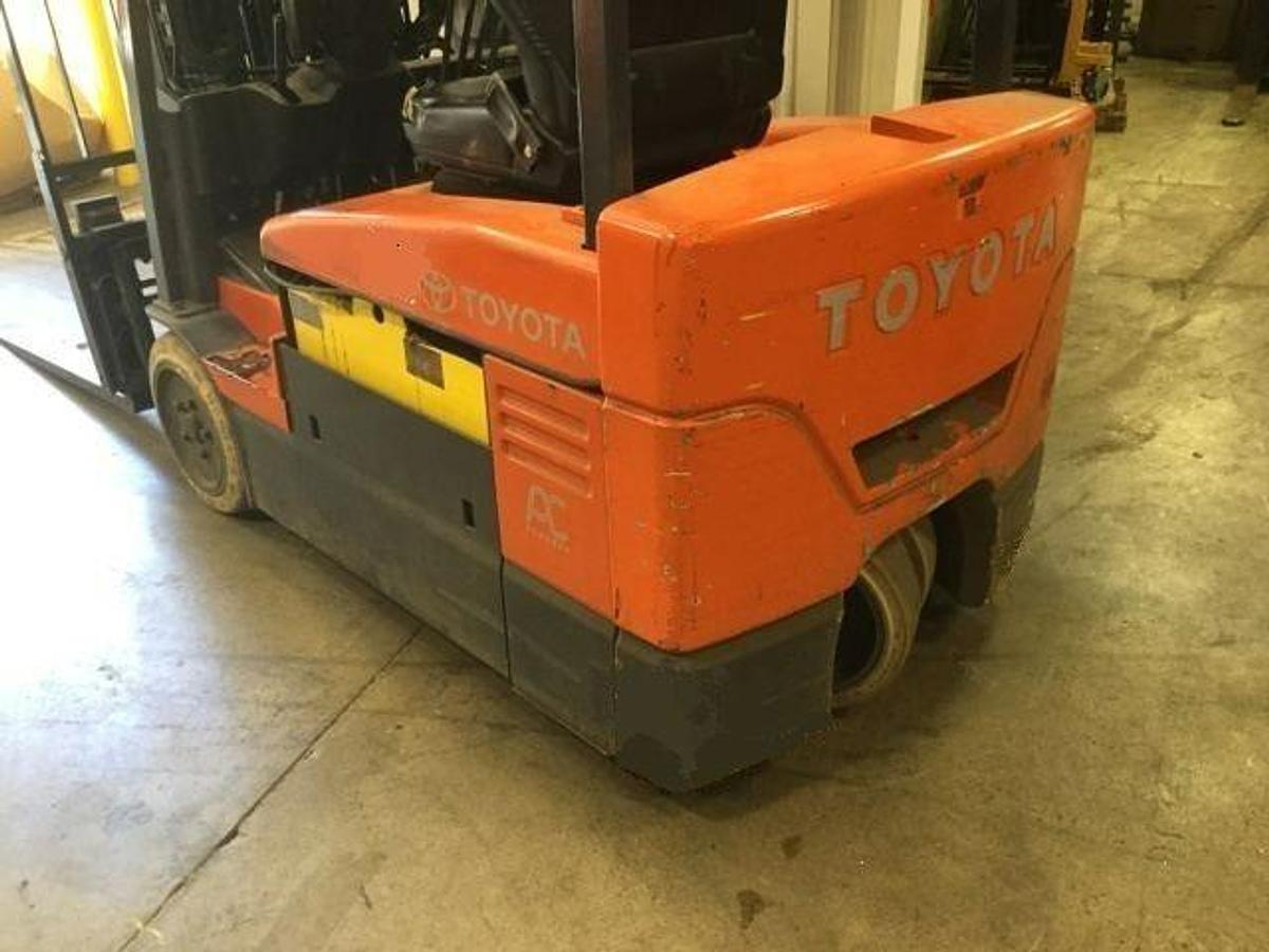 Rear view of Toyota 7FBEU20 electric forklift highlighting counterweight, safety decals, and CSA certification during warehouse deployment
