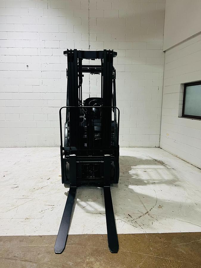 Front view of 2020 Toyota 8FGCU18 propane forklift – CSA-certified 3,500 lb chassis with 189” triple mast, 42” forks, and fork positioner shown reconditioned with safety decals applied, Brampton ON – Premier Lift Equipment