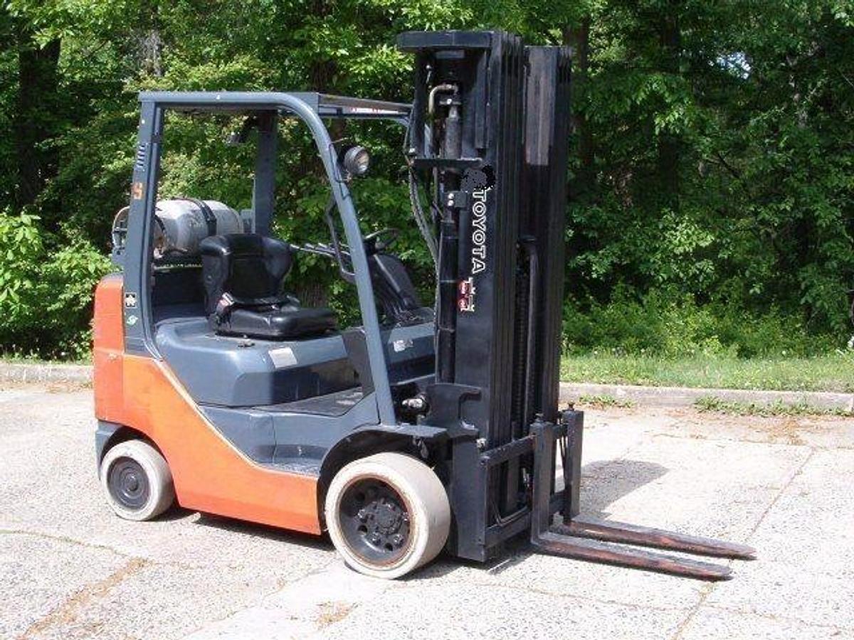 Side view of 2010 Toyota 8FGCU25 propane forklift showing quad mast, 42" forks, side shift, and CSA certification decal during Brampton deployment.