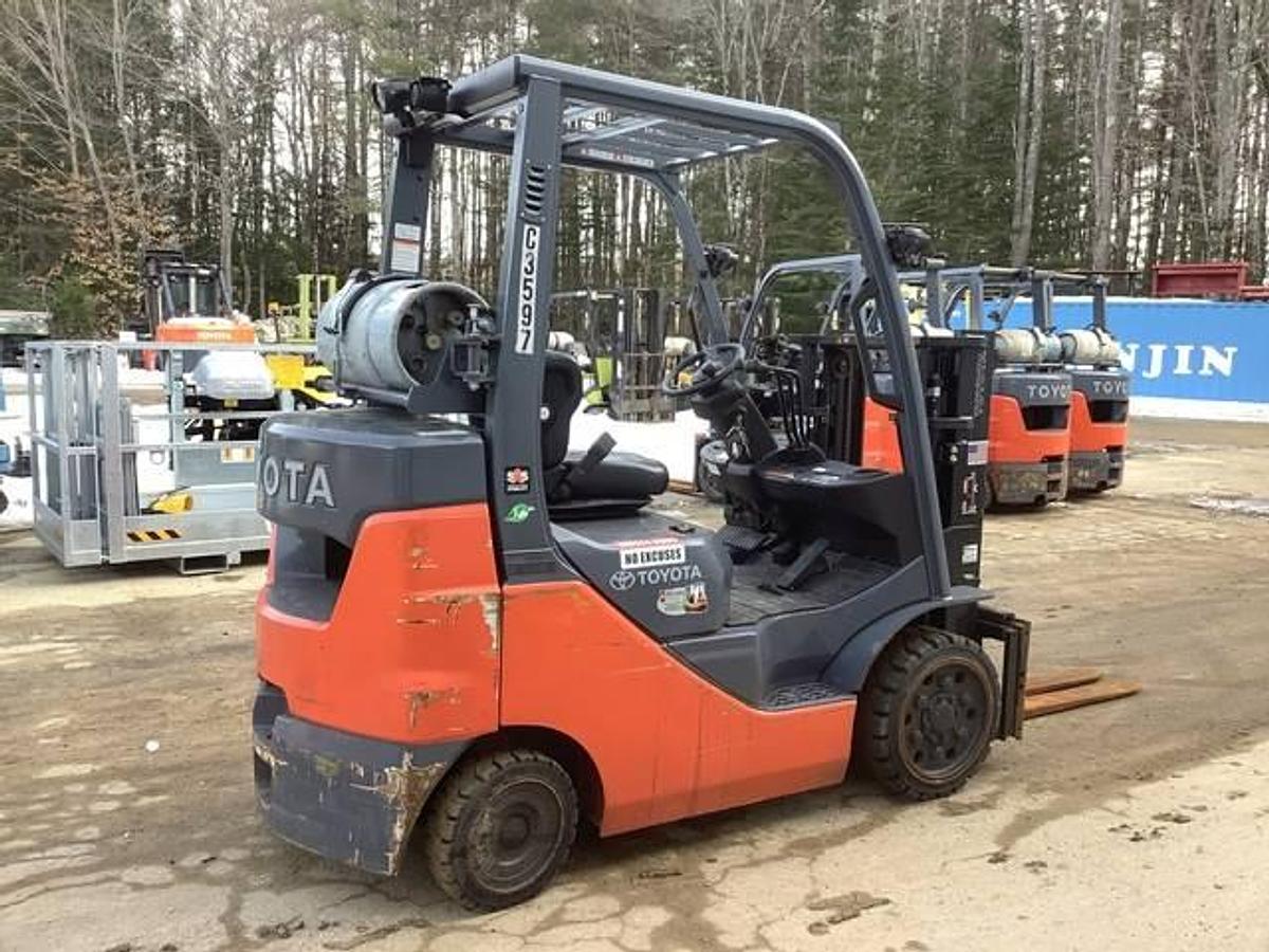Rear side angle view of refurbished 2020 Toyota 8FGCU25 LPG cushion forklift showing counterweight, propane tank mount, and operator cab during Brampton deployment