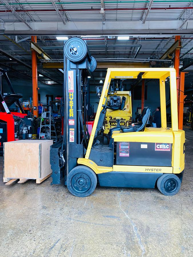 Side view showing Superior Swing Attachment, new 48V battery compartment, turret carriage, cushion tires, and CSA certification decal during Ontario deployment.