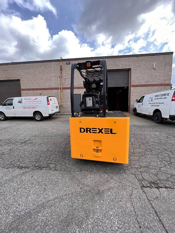 Rear side angle of Drexel SL-40AC SwingMast forklift showing counterweight, rear wheels, and CSA certification during warehouse deployment