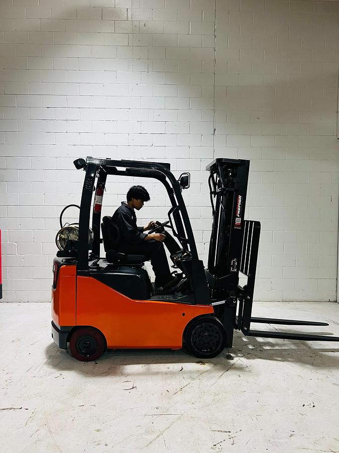 Toyota 8FGCU15 – side profile with operator – propane sit-down forklift with CSA safety decals – Brampton ON