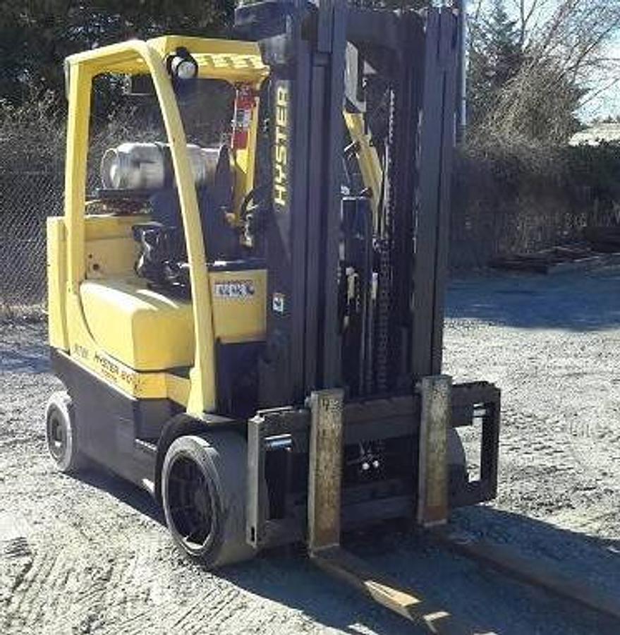 Opposite front side view of refurbished 2015 Hyster S80FT BCS LP Gas forklift showing counterweight, cab enclosure, 42" forks, 185" lift height, solid tires, short footprint Boxcar Special design, and CSA certification decal during Ontario deployment.