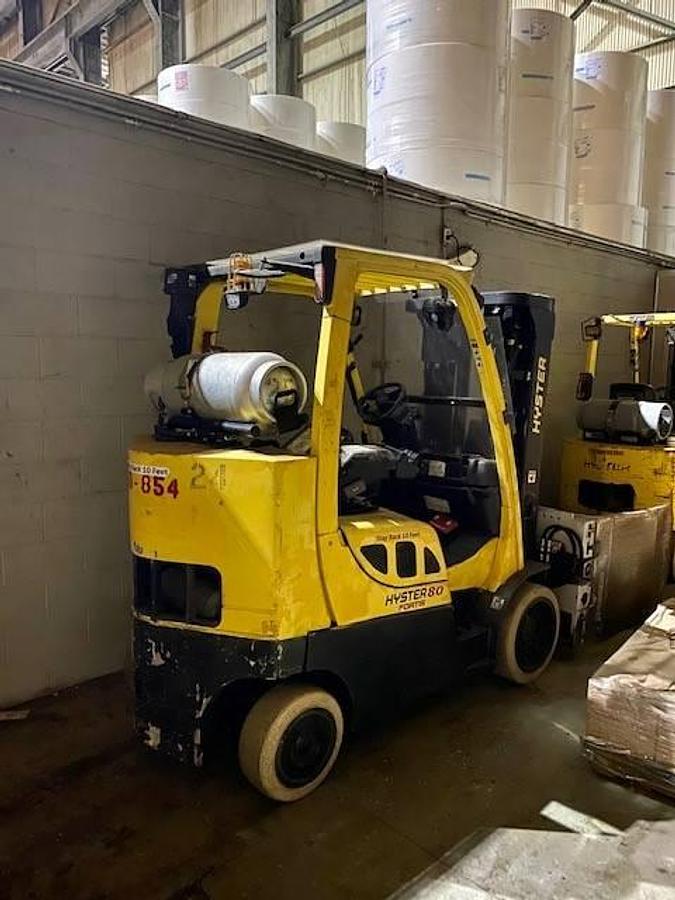 Rear view of refurbished 2006 Hyster S80FTBCS LPG cushion forklift showing counterweight, rear tires, and propane tank bracket during Brampton deployment