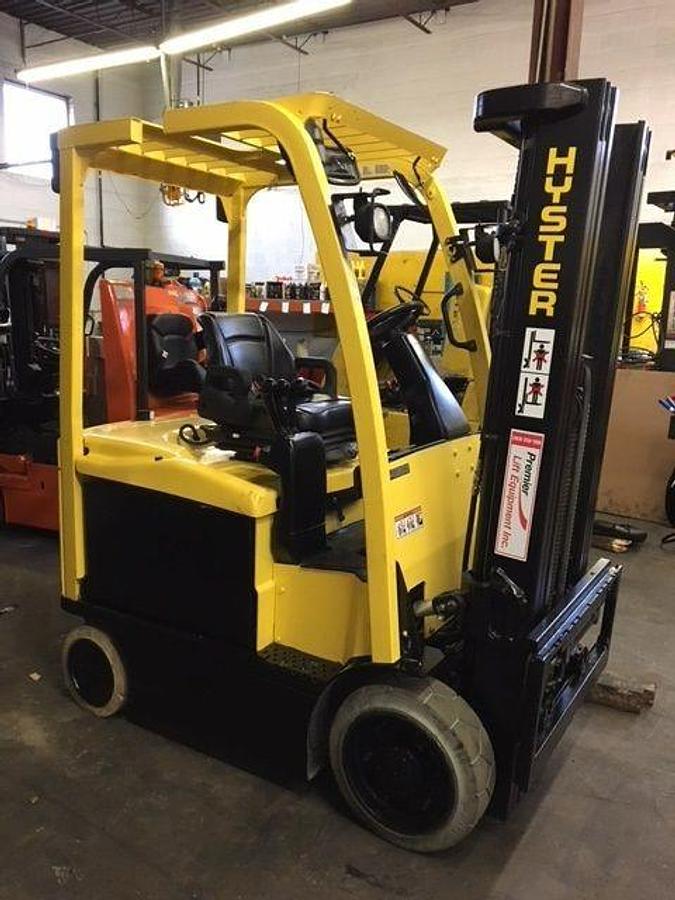 Front view of refurbished 2014 Hyster E55XN electric forklift showing 3‑stage mast, 48" forks, side shift, non‑marking tires, and CSA certification decal during Ontario deployment.