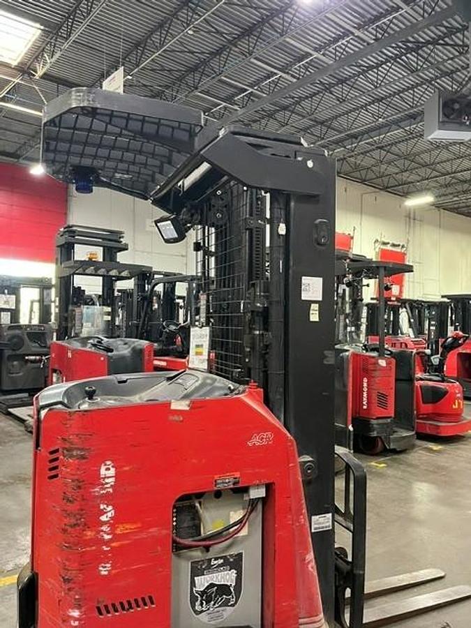 Close‑up side view of 2020 Raymond 730‑R45TT reach carriage, mast rails, and fork assembly — refurbished 4,500 lb CSA‑certified single‑reach forklift