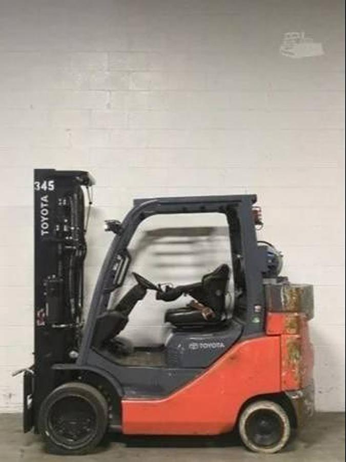 Opposite side view of 2019 Toyota 8FGC45U-BCS propane forklift showing 4-way hydraulic valve block, mast tilt cylinders, cushion tires, and CSA-certified chassis – unit staged in Brampton ON