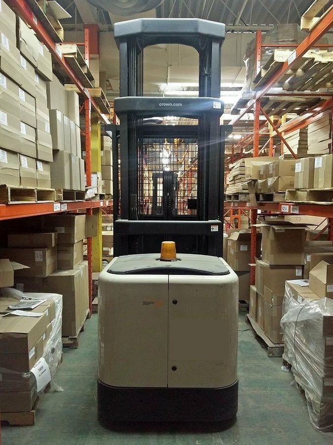 Back view of refurbished 2007 Crown SP400‑30 electric order picker showing rear chassis, 24 volt battery compartment, operator platform, and CSA certification decal during Ontario deployment.